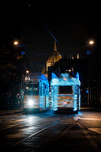 white and blue bus at night thumbnail
