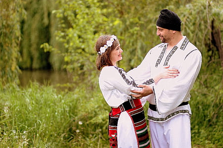 couple holding each other near green trees thumbnail