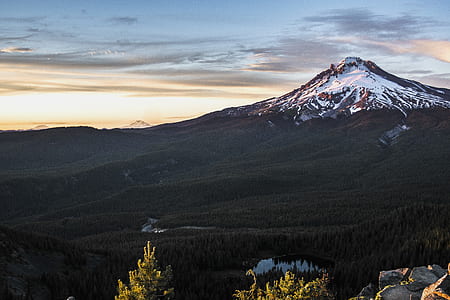 snow capped mountain under cloudy sky thumbnail