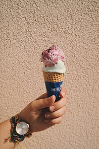 person holding white and pink ice cream thumbnail
