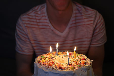 man facing candle cake thumbnail