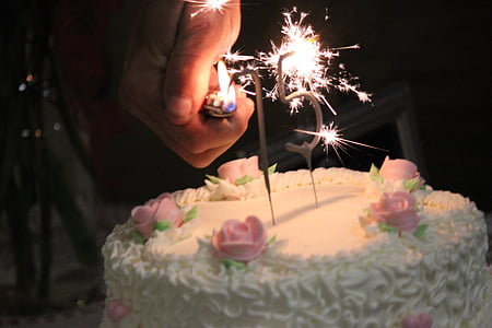 selective focus photography of round white and pink icing-covered cake thumbnail