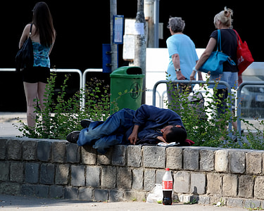 man sleeping on brown concrete surface thumbnail