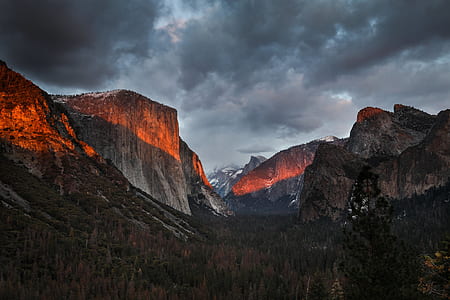 gray and brown mountain under white clouds thumbnail