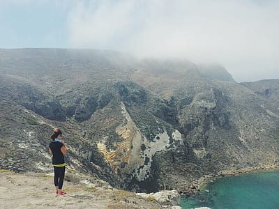 woman in black leggings standing on cliff thumbnail