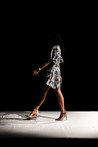 walking woman in white-and-black mini dress thumbnail