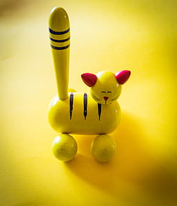 Yellow and Red Cat Figurine on Yellow Top thumbnail