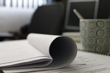 white book beside green and white ceramic mug thumbnail