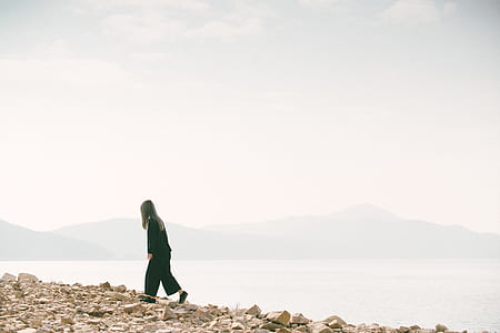 woman walking on shoreline thumbnail