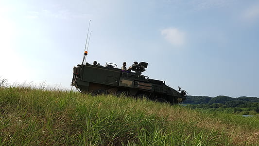 battle vehicle on green grass field under blue sky at daytime thumbnail