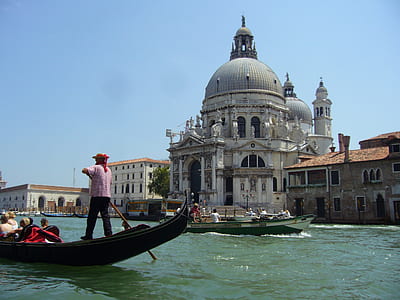 man paddling boat near mosque thumbnail