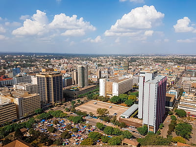 aerial photography of buildings under white clouds at daytime thumbnail