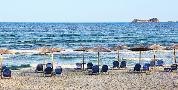 blue chaise lounge lot beside sea thumbnail