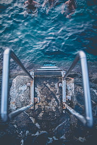 closeup photo of gray metal ladder on rack thumbnail