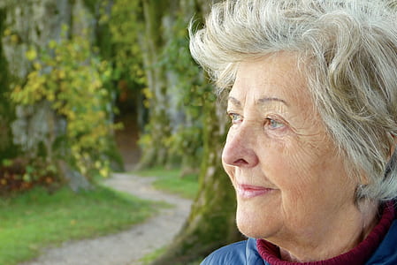 woman wearing blue and red shirt looking to the left thumbnail