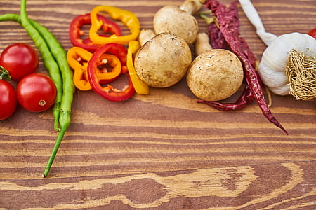 sliced bell pepper, chili, mushrooms, garlic bulb, cherry tomatoes on board thumbnail