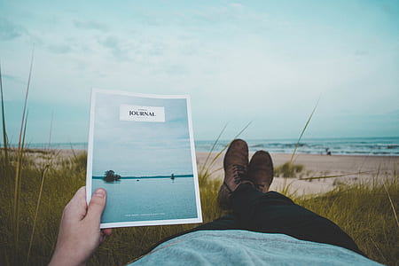 person holding Journal book thumbnail