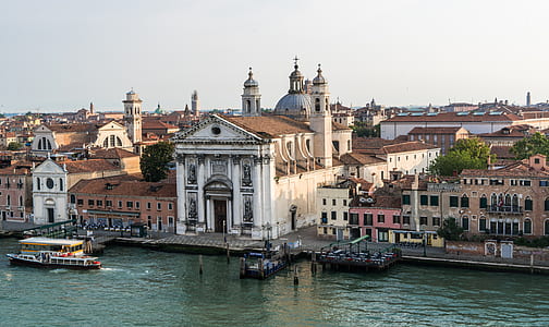 white and brown concrete church beside body of water thumbnail