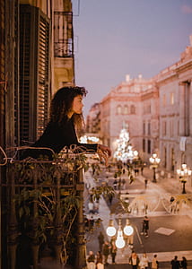 woman in black long-sleeved top on terrace thumbnail