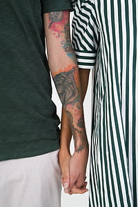 Couple’s arms with tattoos thumbnail