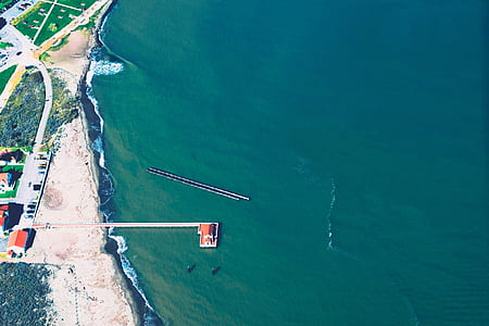aerial photo of sea beside the village thumbnail