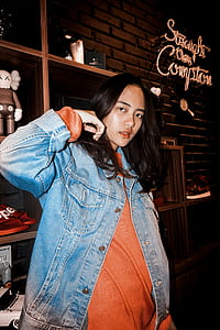 woman in blue denim jacket standing near wooden shelf thumbnail