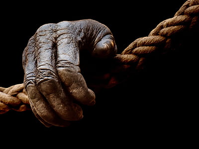 right human hand on brown rope thumbnail