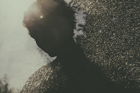 silhouette photo of person on sprinkled water thumbnail