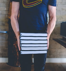 person carrying books thumbnail