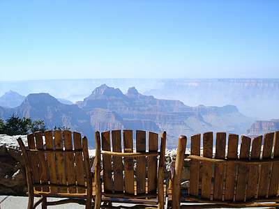 brown wooden chairs beside the ledge thumbnail