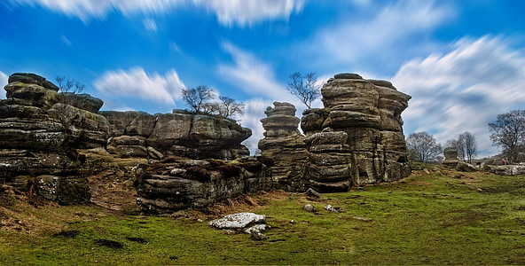 grey rock formation on green grass land thumbnail
