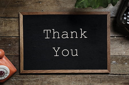 black and brown wooden Thank You signage on top of brown table thumbnail