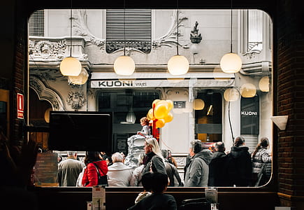 people standing near store window thumbnail