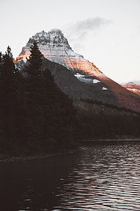mountain and forest near body of water thumbnail