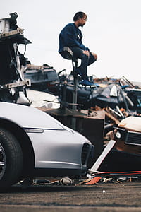 photo of man sitting on gray metal part thumbnail