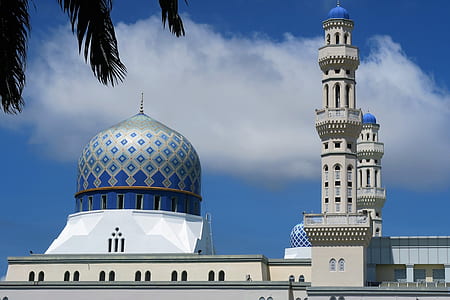 blue and white mosque under cloudy sky at daytime thumbnail