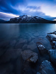 mountain surrounded by body of water thumbnail
