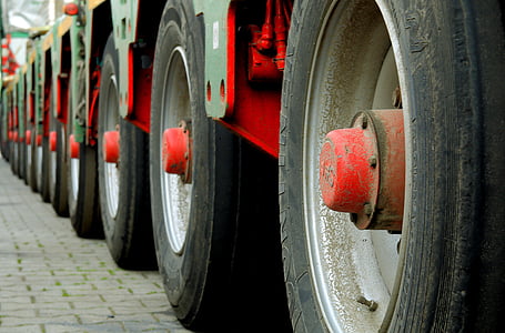 green trailer truck on paver brick during daytime thumbnail