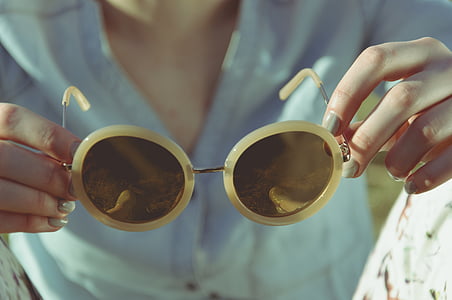 selective focus photography of beige framed yellow lens sunglasses thumbnail