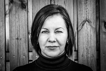 portrait photo of woman wearing turtle neck shirt thumbnail