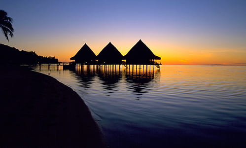 silhouette of three house in the middle of the sea thumbnail