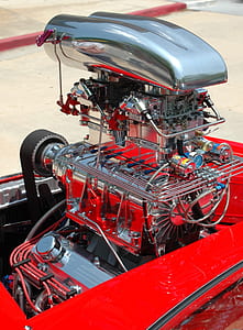 red and silver engine part on surface thumbnail