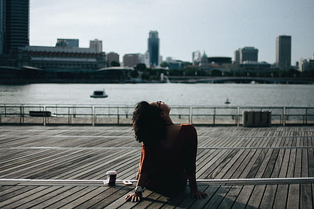 woman sitting on bench staring at sky thumbnail