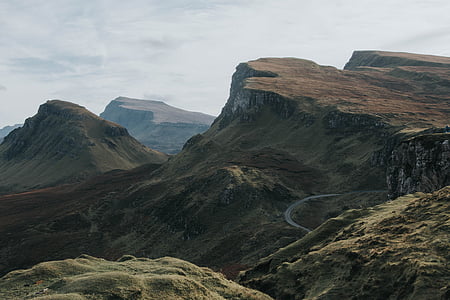 photo of brown and green hill under white clouds at daytime thumbnail