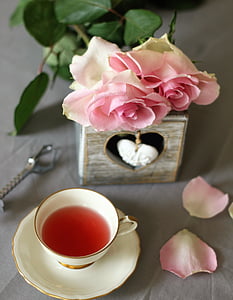 pink rose flowers near white ceramic cup and saucer thumbnail
