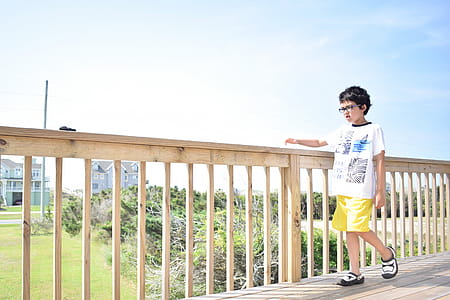 Boy Walking on Wooden Bridge. thumbnail