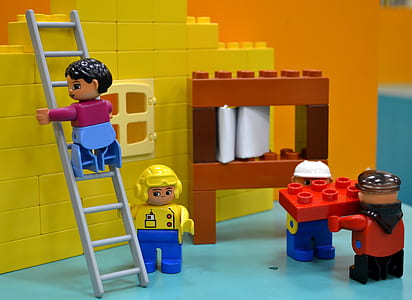 Lego minifig toys on teal surface thumbnail