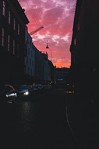 silhouette of vehicles parked on street thumbnail