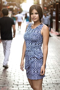 woman wearing black and white tank minidress standing on brick pavement during day thumbnail