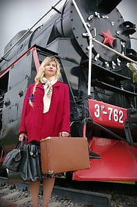 woman standing beside the train thumbnail